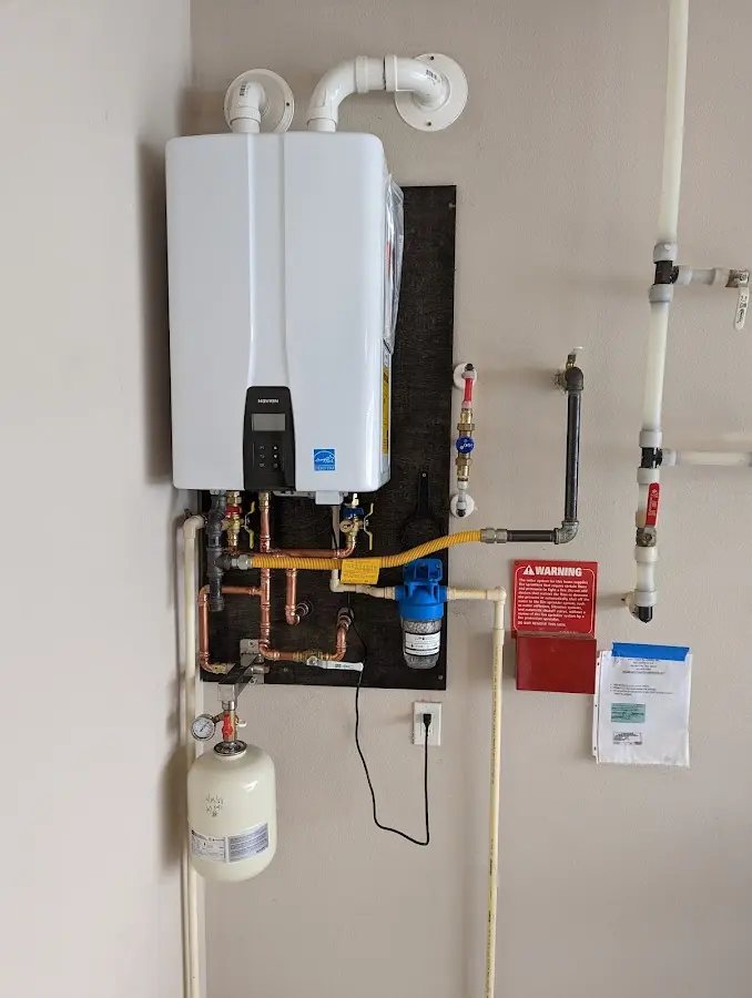 Professional plumber installing copper piping in a Gray home
